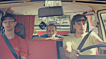 Szenenbild: Enea und seine beiden Freunde im Inneren eines VW-Busses